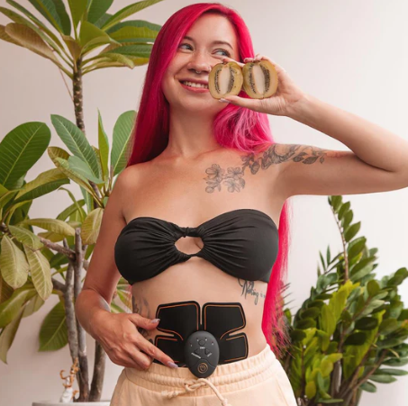 Woman wearing a LePeach EMS ab trainer