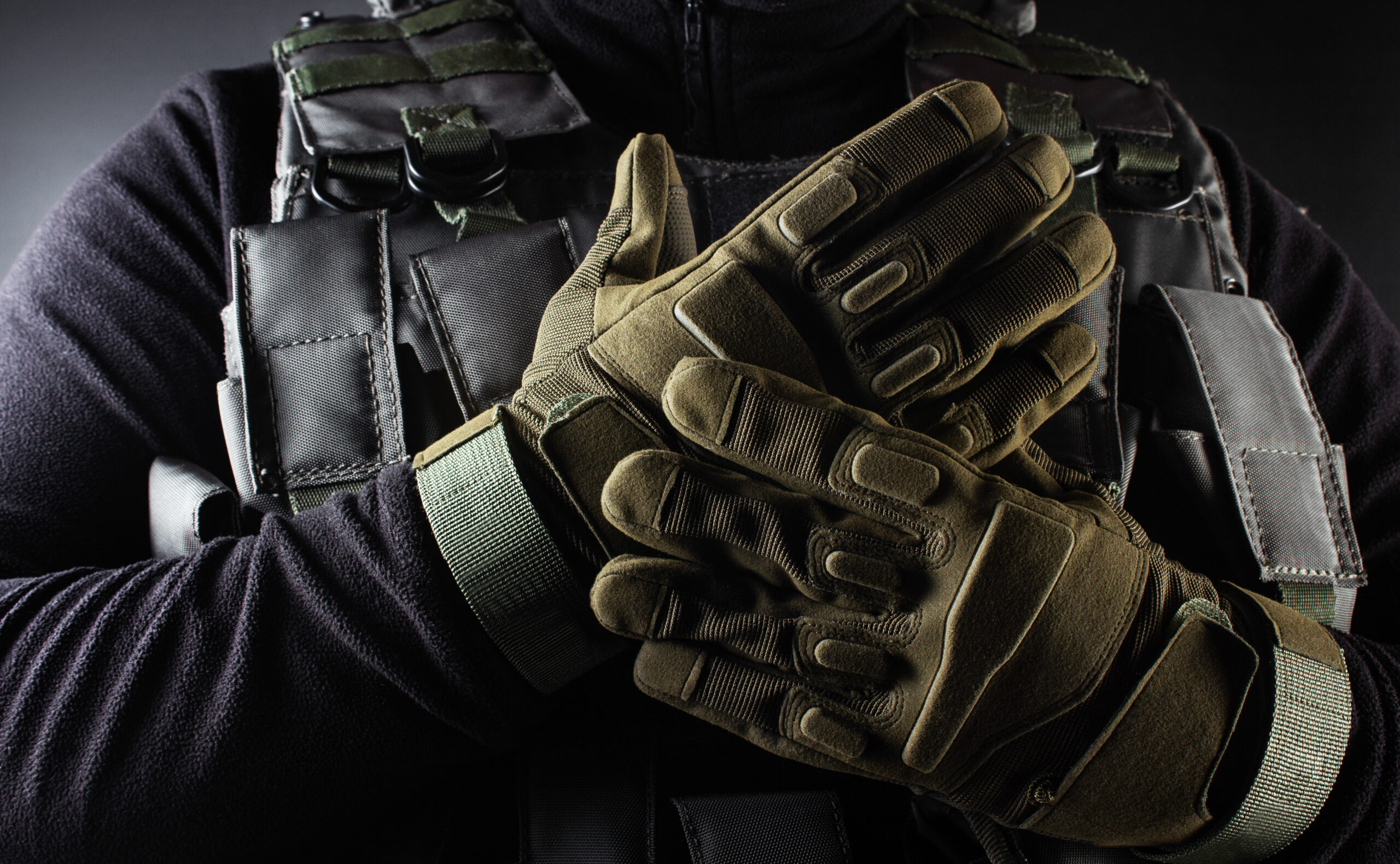 Soldier in tactical gloves and plate carrier