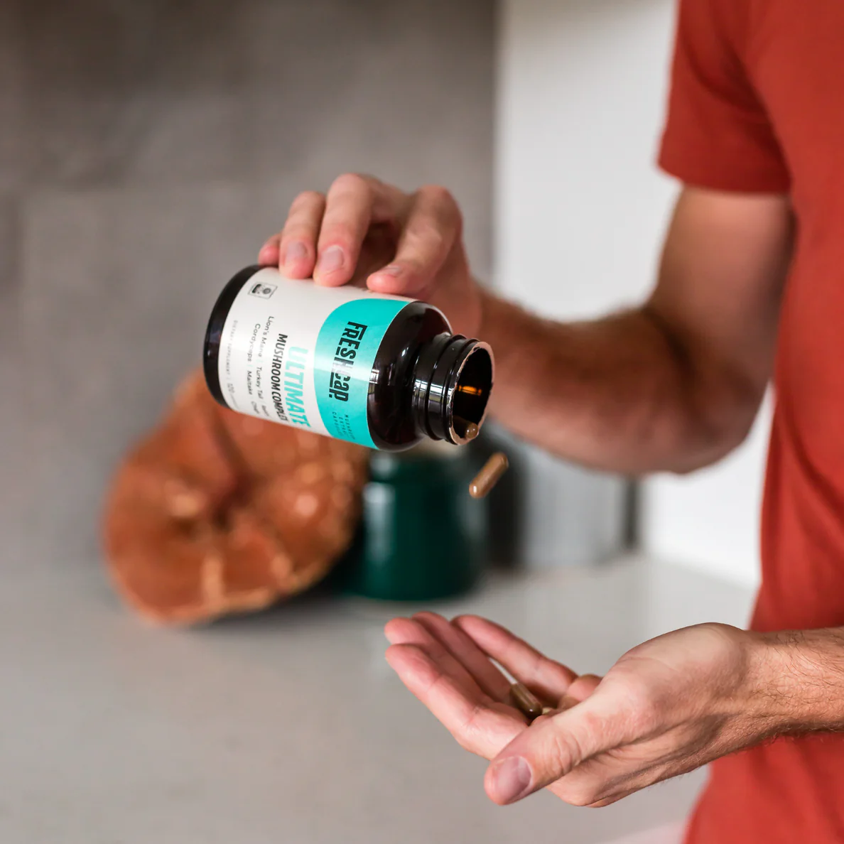 Man pouring FreshCap mushroom capsules into his hand