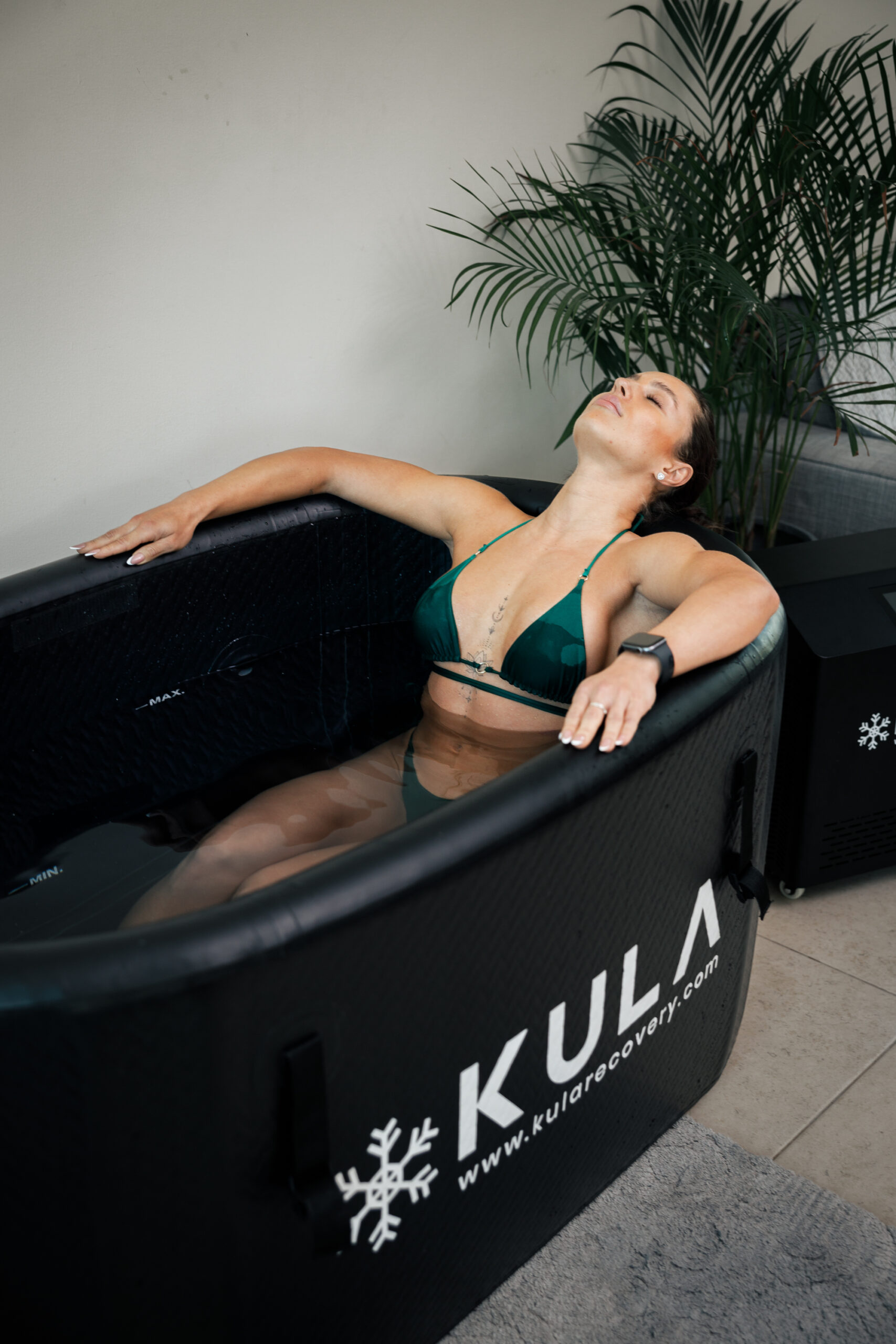 Woman relaxing in a KULA cold plunge tub