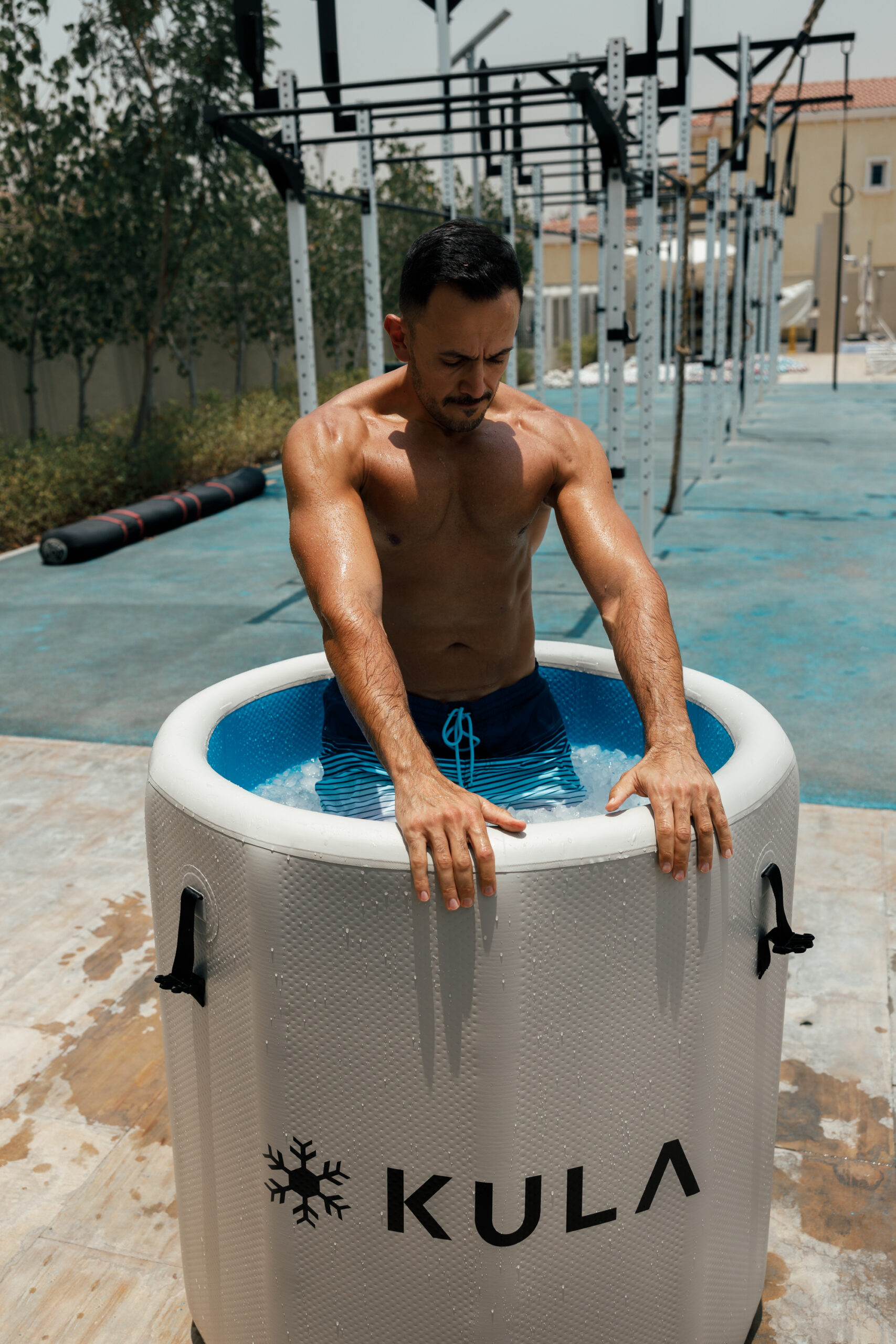 Man stepping into a KULA barrel cold plunge