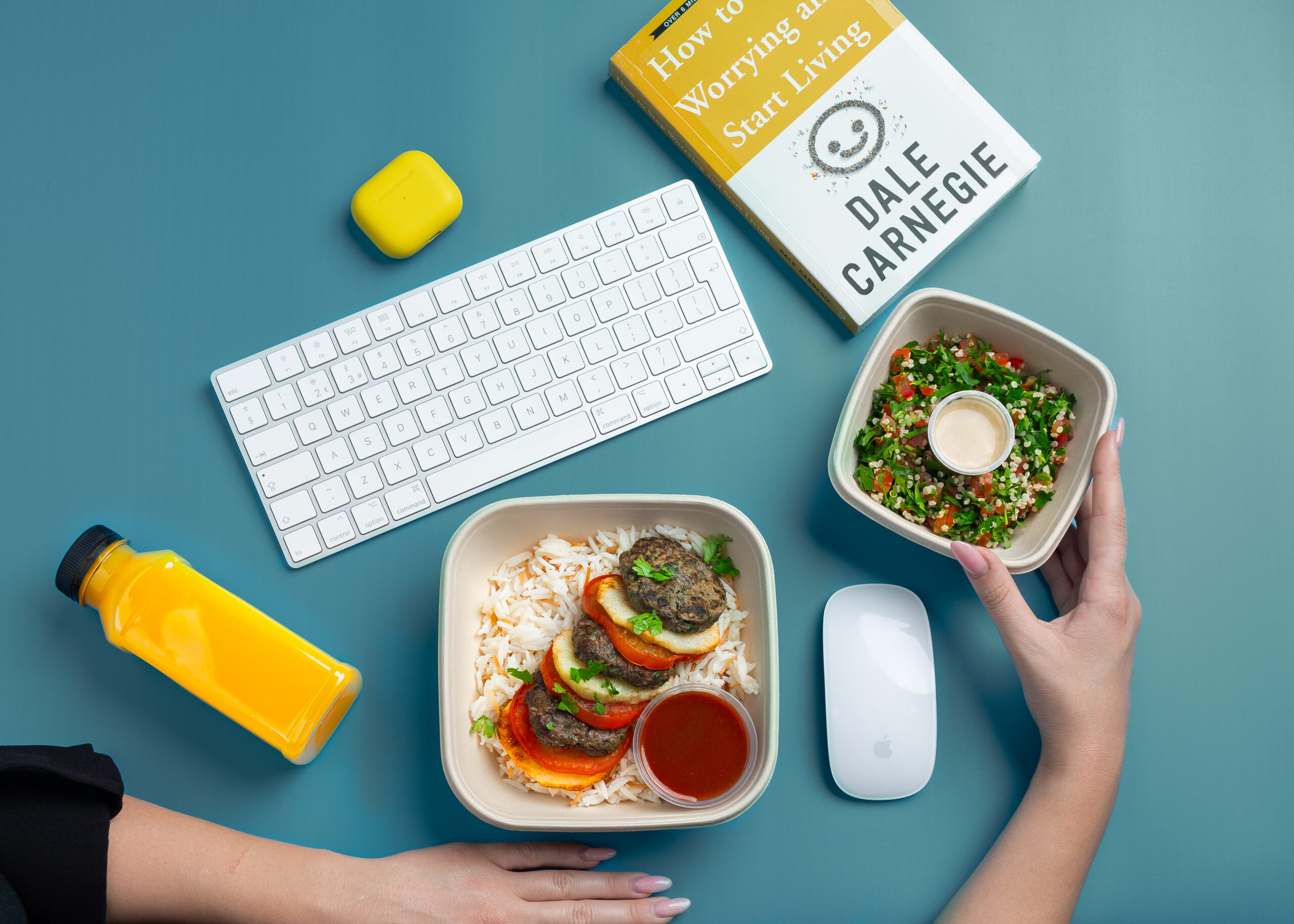 Fitlab meal boxes next to a keyboard at a desk