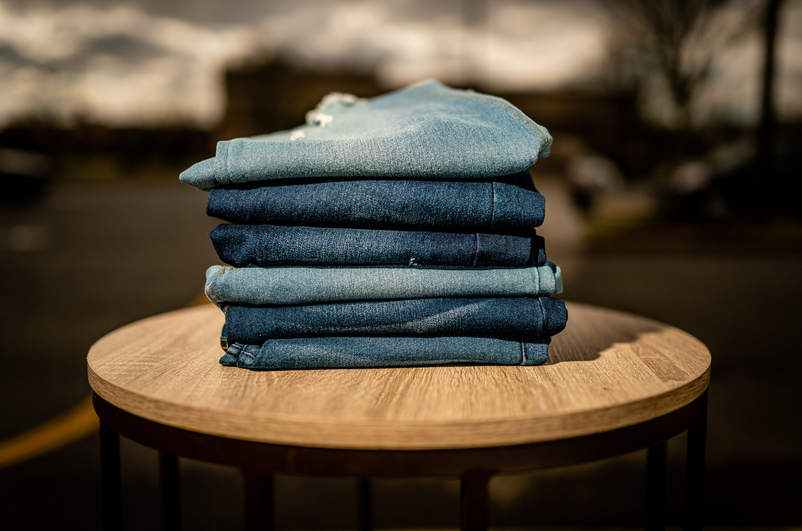 Stack of denim jeans at Sybaritic Boutique