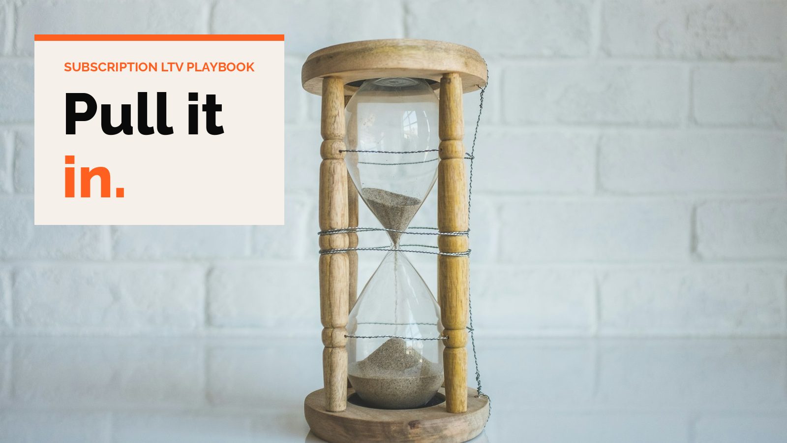 A wooden hourglass on a white table