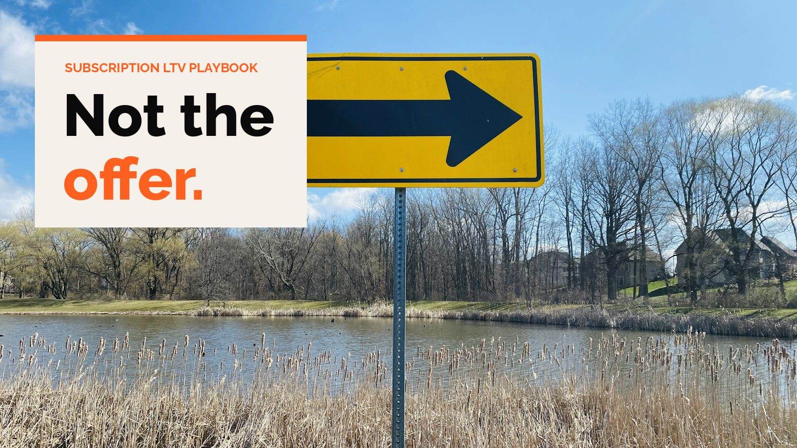 A yellow road sign with a black arrow pointing right