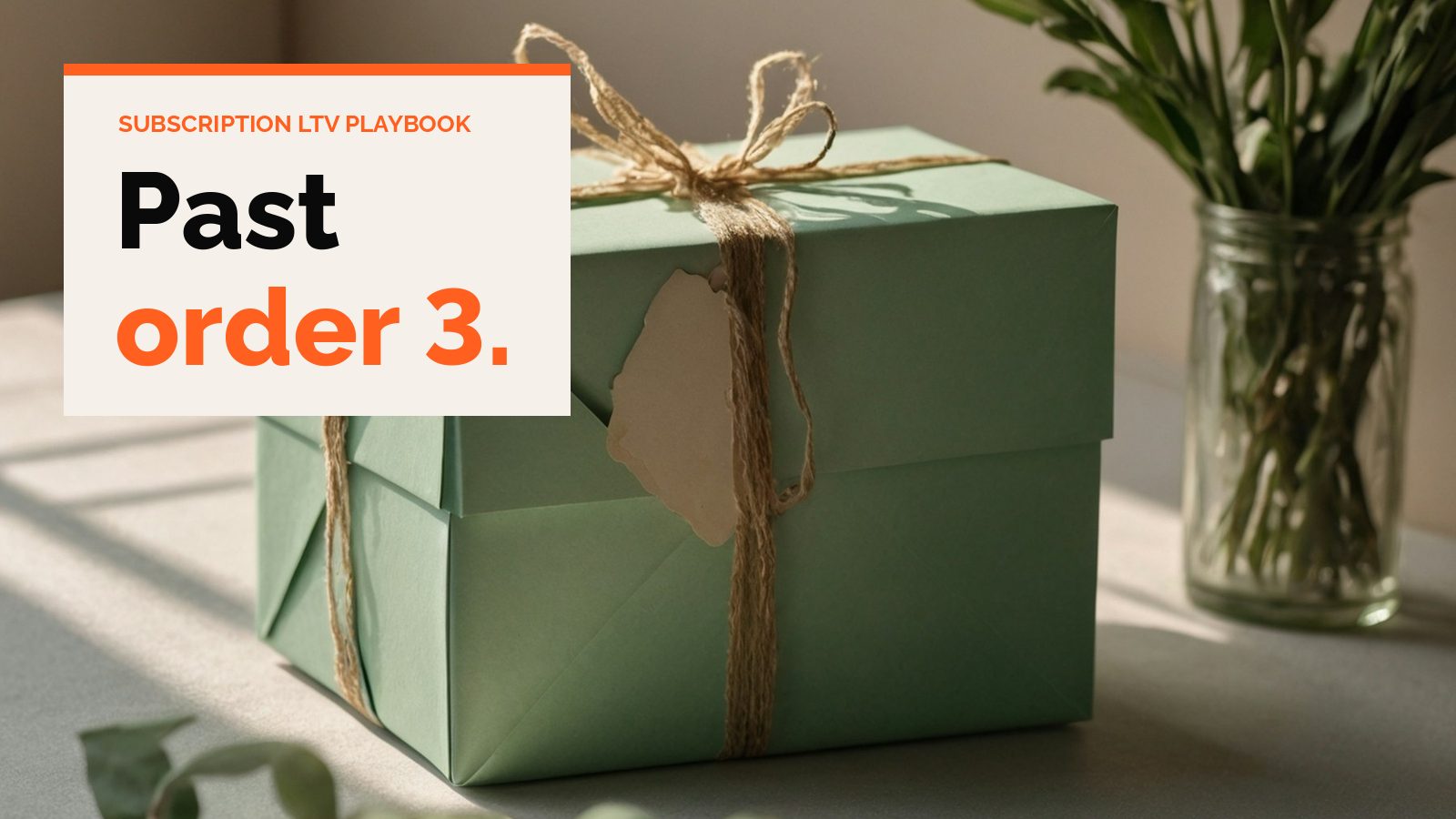 A green gift box tied with twine next to a jar of leaves